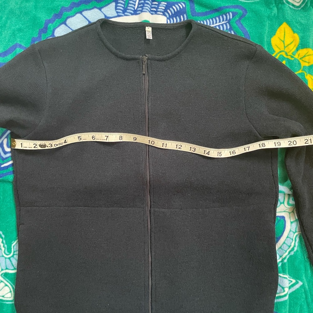 Round neck zippered dark navy top with two hidden side pockets.